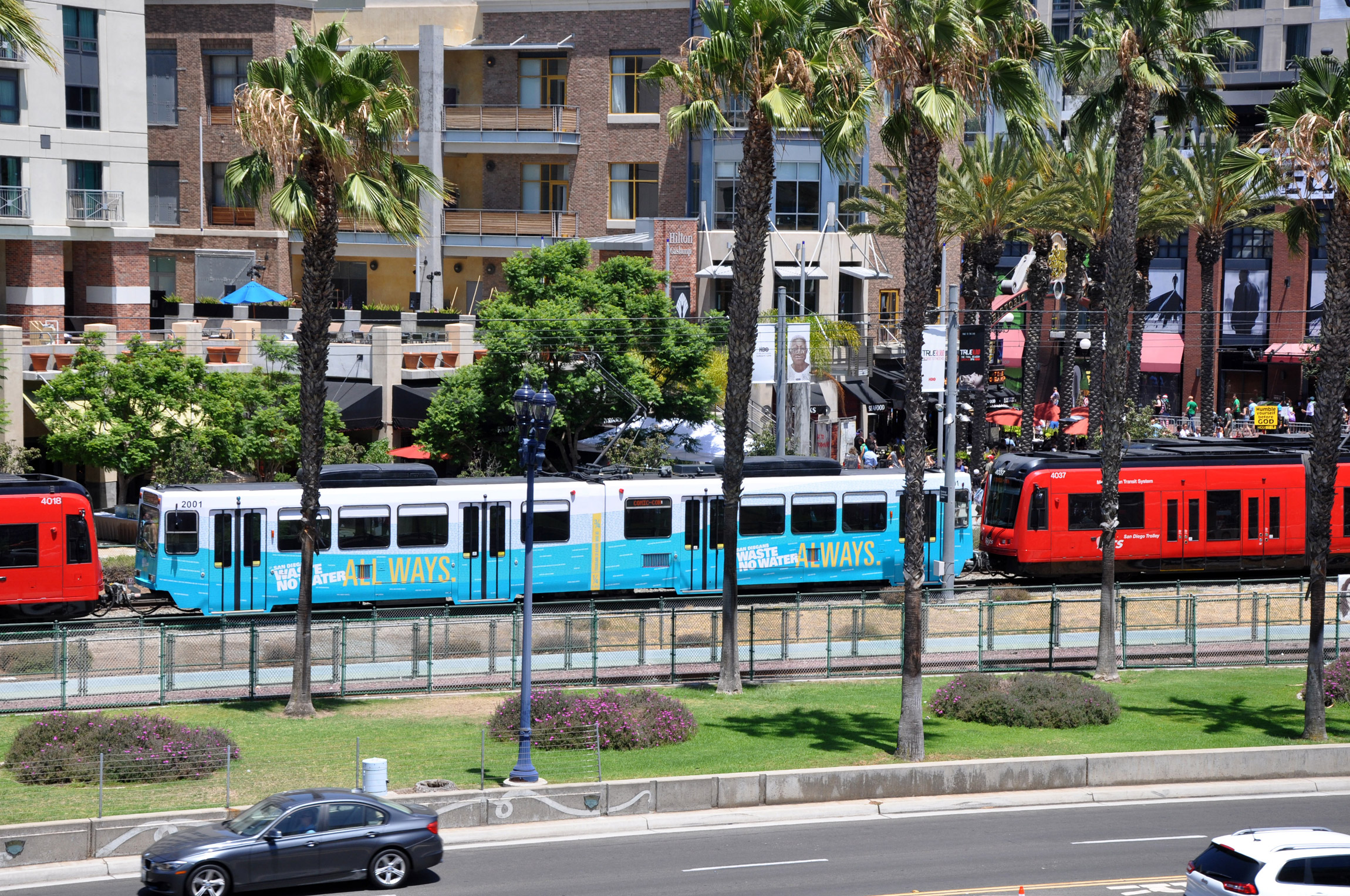 A trolley car wrapped in campaign graphics passes through downtown San Diego